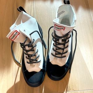 Dipped canvas high top sneakers in white and black with laces.